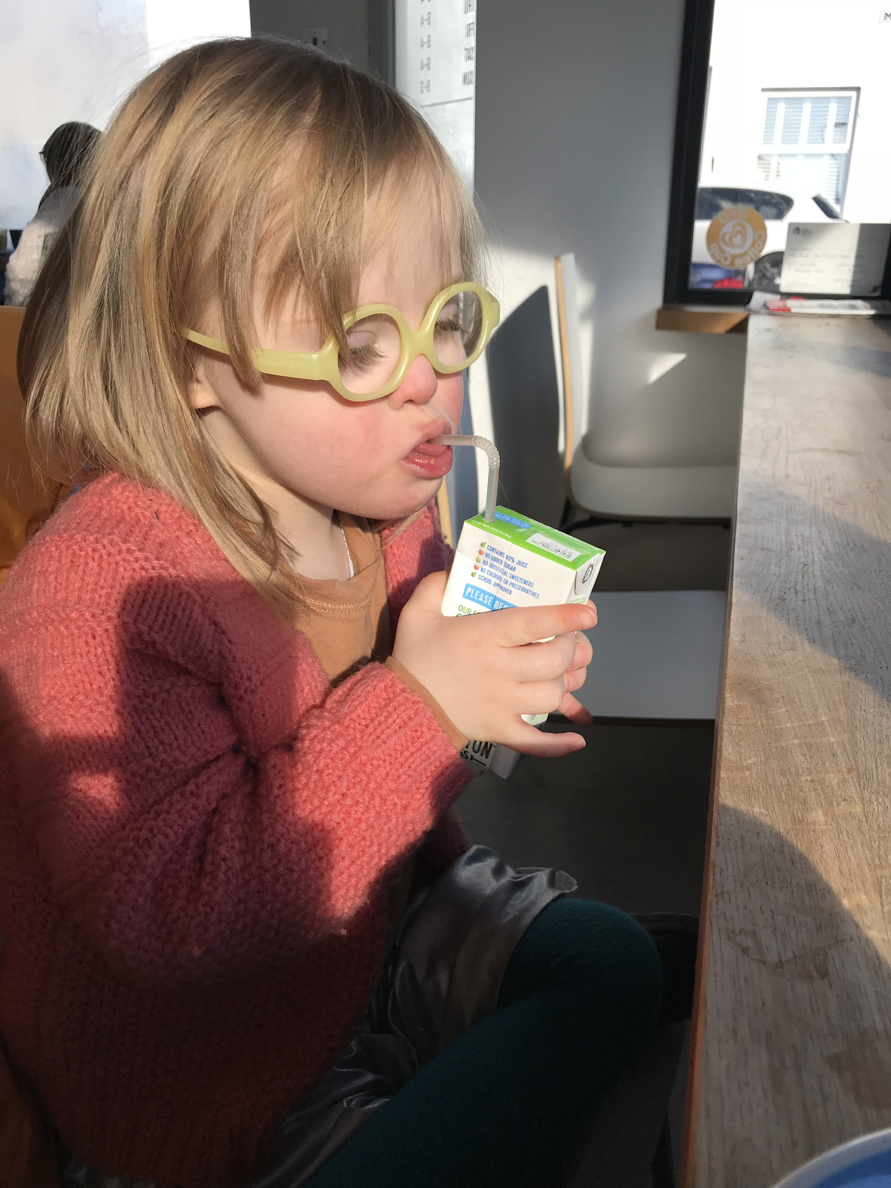 Audrey drinks her juice from a straw