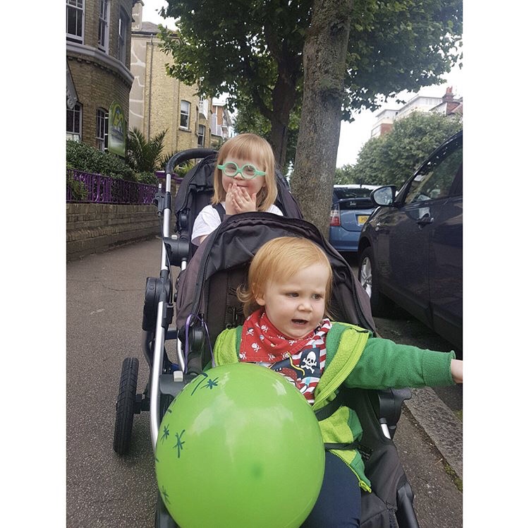 Two children in a double buggy